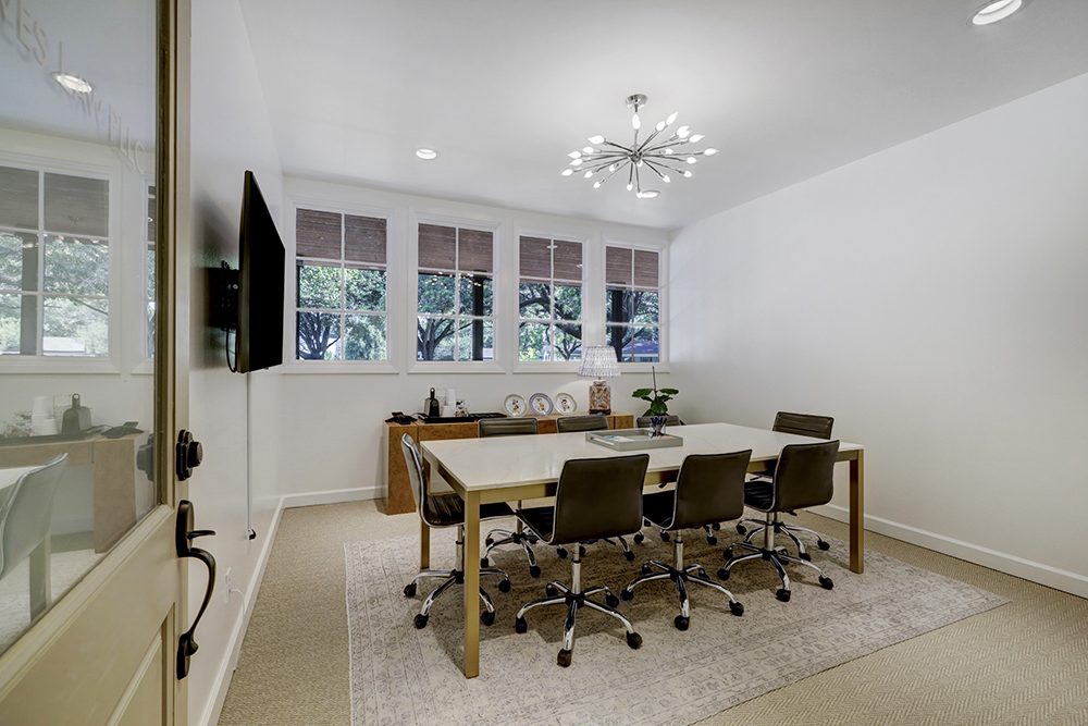 Conference room with table for six and wall-mounted display