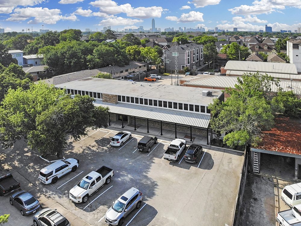 Aerial view of the building and parking with the Houston skyline