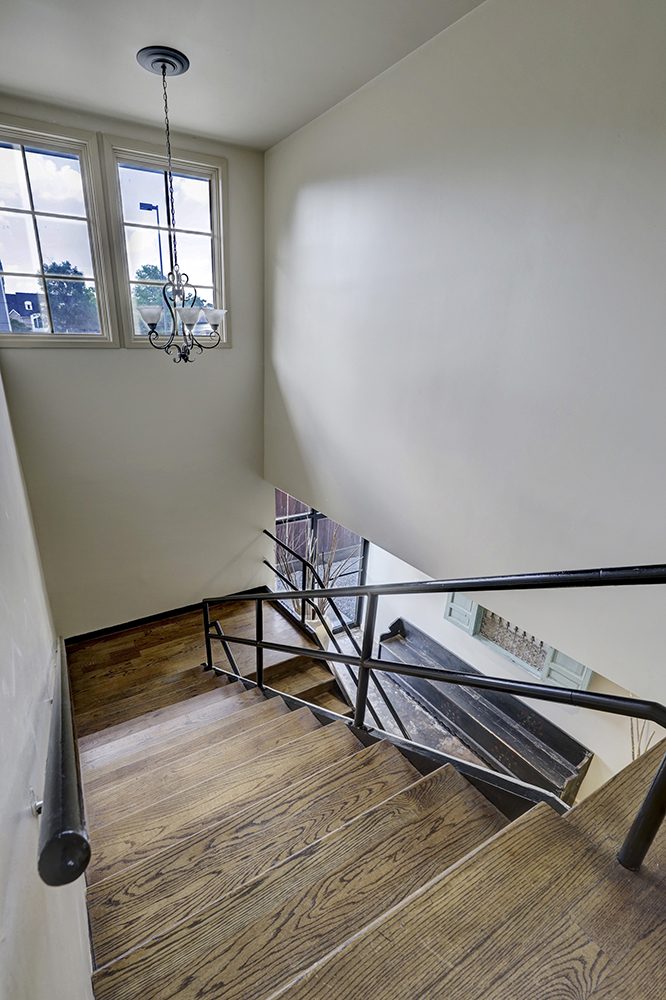 Stairwell with wood treads and chandelier